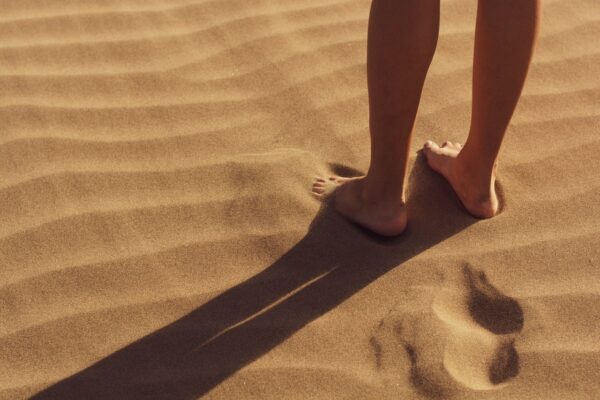 Someone is walking on the sand