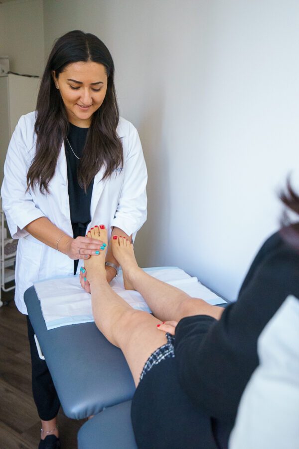 Podiatrist providing specialized care for Plantar Fasciitis, addressing symptoms and conducting an examination to identify tenderness and foot biomechanics.