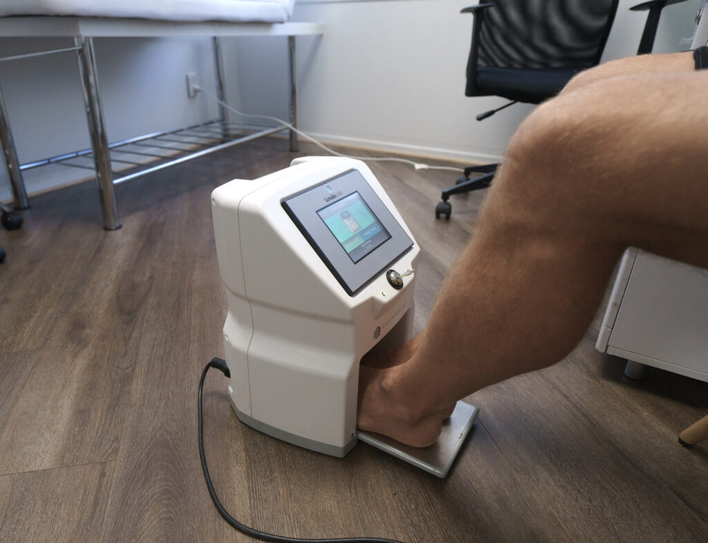Doctor examine the patient's foot via machine