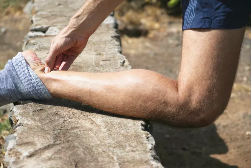 Someone rest his leg on the rock