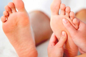 Doctor taking care of the patient's feet